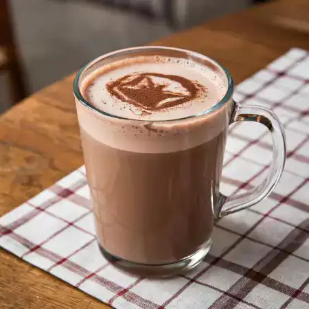 Hot chocolate drink made by melting 30 grams of ChocoNature 55 percent dark chocolate bar in steaming milk simple recipe